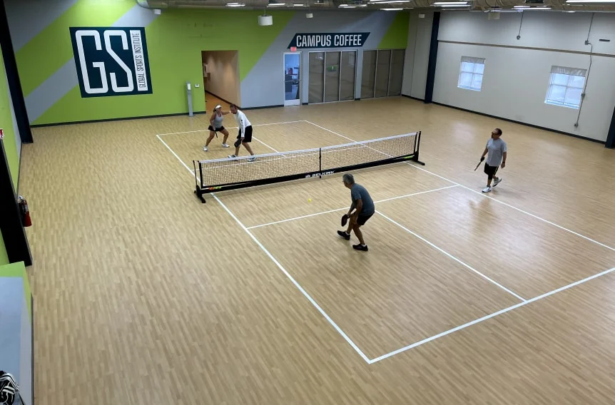 Pickleball players on an indoor court at Global Sports Institute